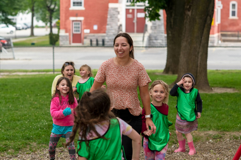 Teacher playing with students on the playground