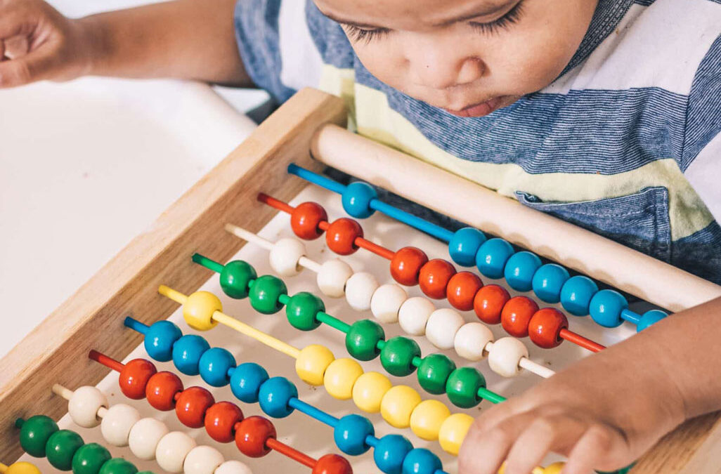 child working on abacus