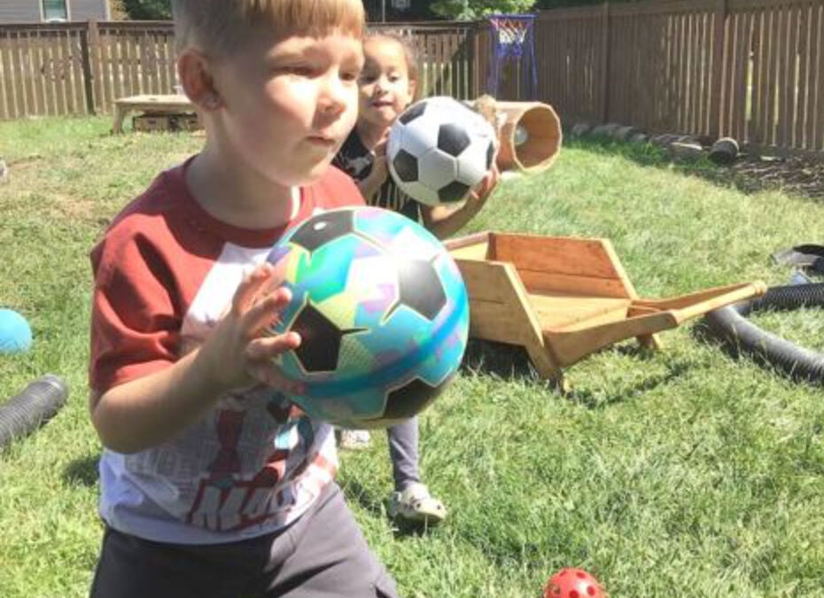 boy and girl students playing ball on the playgound